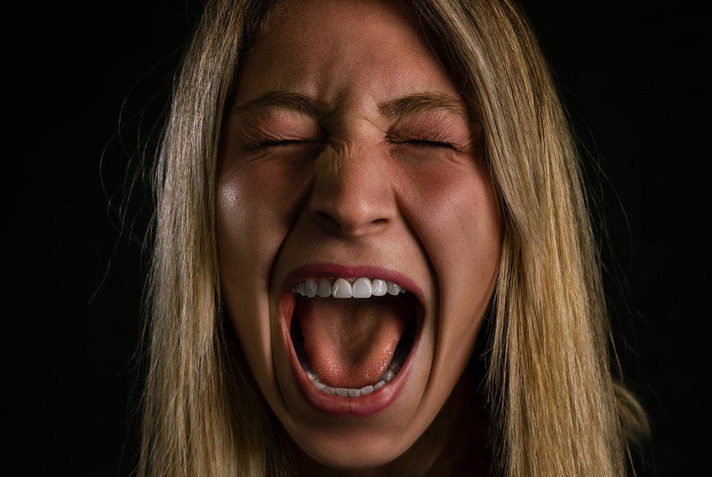 A young woman screaming at night