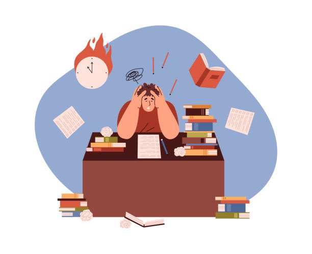 Frustrated Student sitting at desk surrounded by books and work, feeling stressed