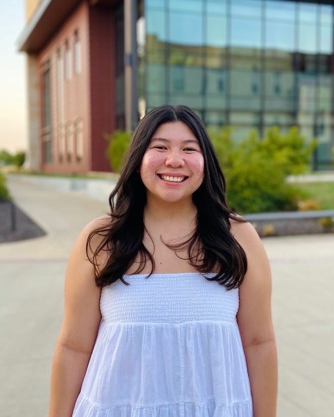 Picture of Isabella Grover smiling in white shirt. 