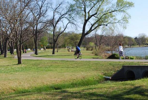 Shows the Beauty of White Rock Lake with trees in the background overlooking the lake.